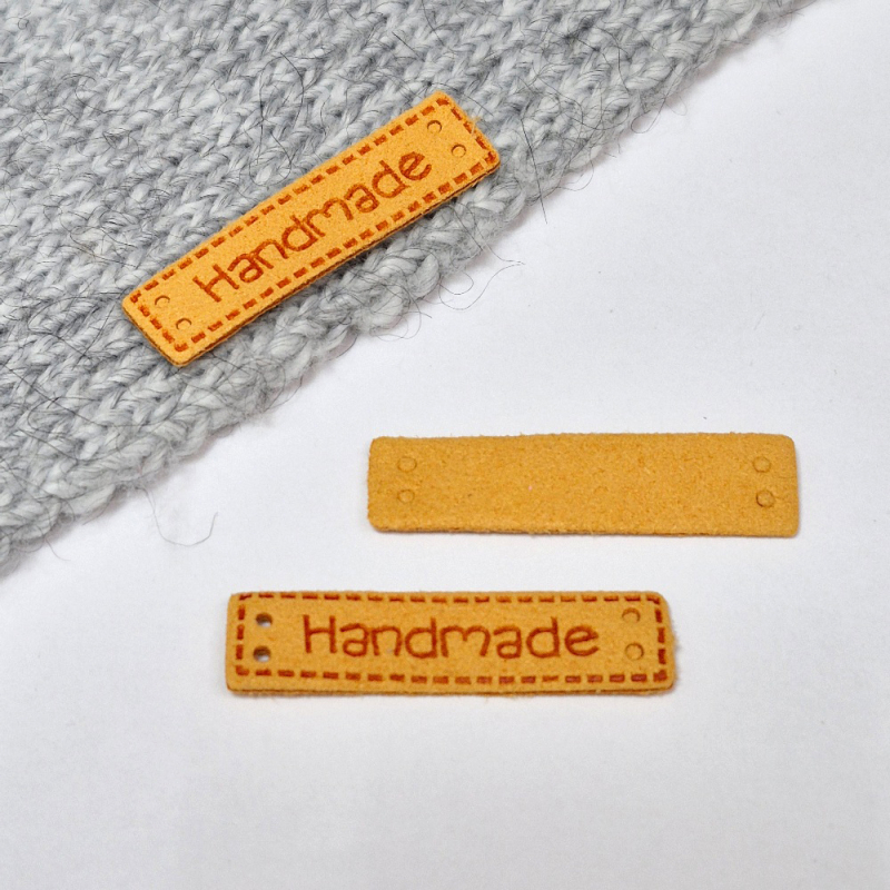 картинка Бирка  "Hand made"  кожаная 39×10мм цв.оранжевый от магазина Пряжа Макошь Ярославль